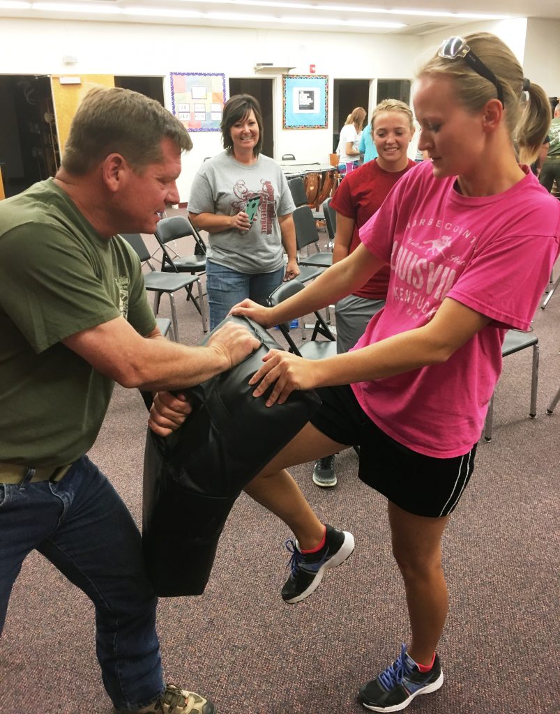 Instructor Lew works with a student on knee strikes during the Personal Safety Class. The students were very motivated and the instructors were very sore!